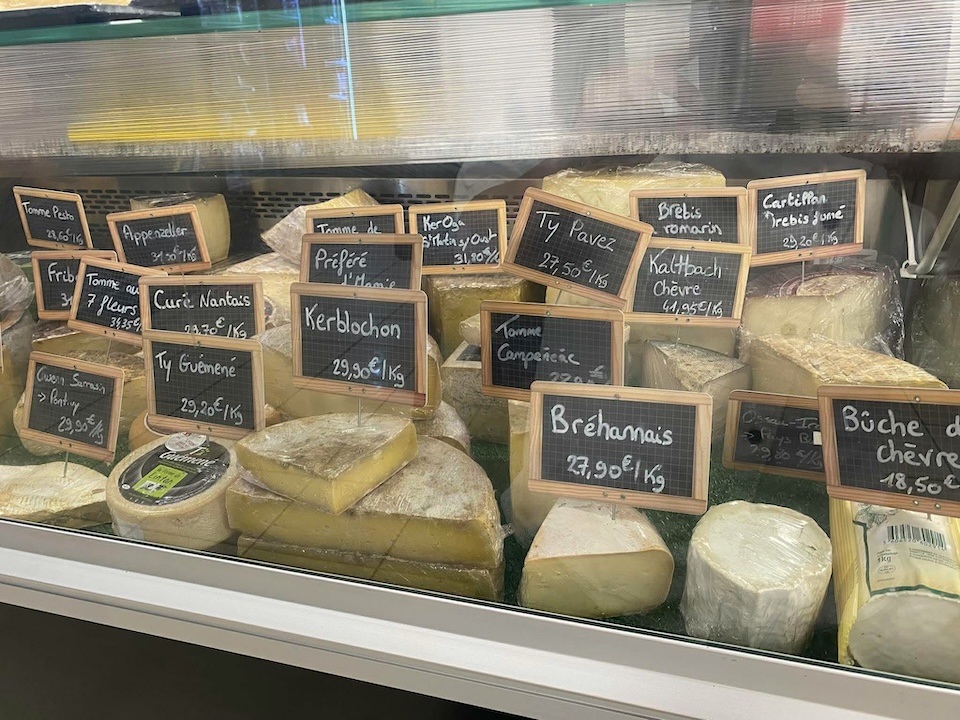 Comptoir frais de la cremerie/fromagerie d'Au Marché de l'Oust sur lequel sont disposées des fromages